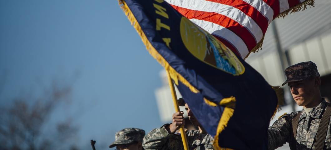 image of ROTC students waving US and Montana flags