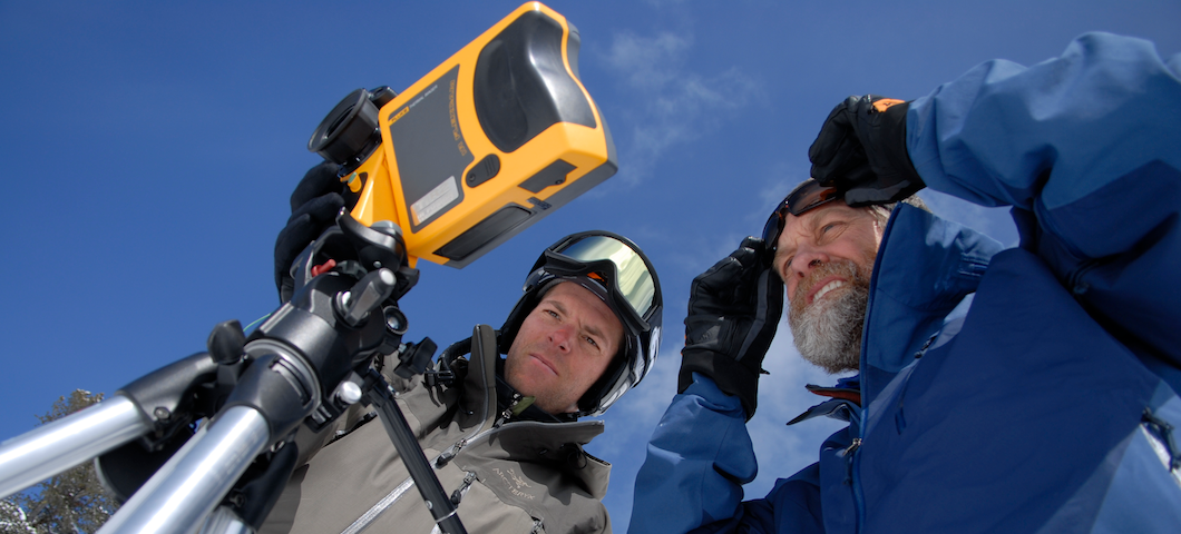 MSU researchers looking at device for snow science outdoors under blue sky